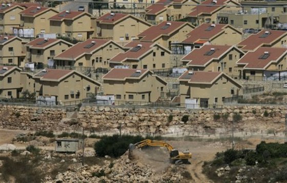 Israeli earth-moving equipment works in the Jewish settlement of Kiryat Netafim, near the West Bank village of Salfit. Top Palestinian official Saeb Erekat said Wednesdaythat Palestinians will ask the U.N. Security Council in the coming days to condemn Israeli settlement construction. 